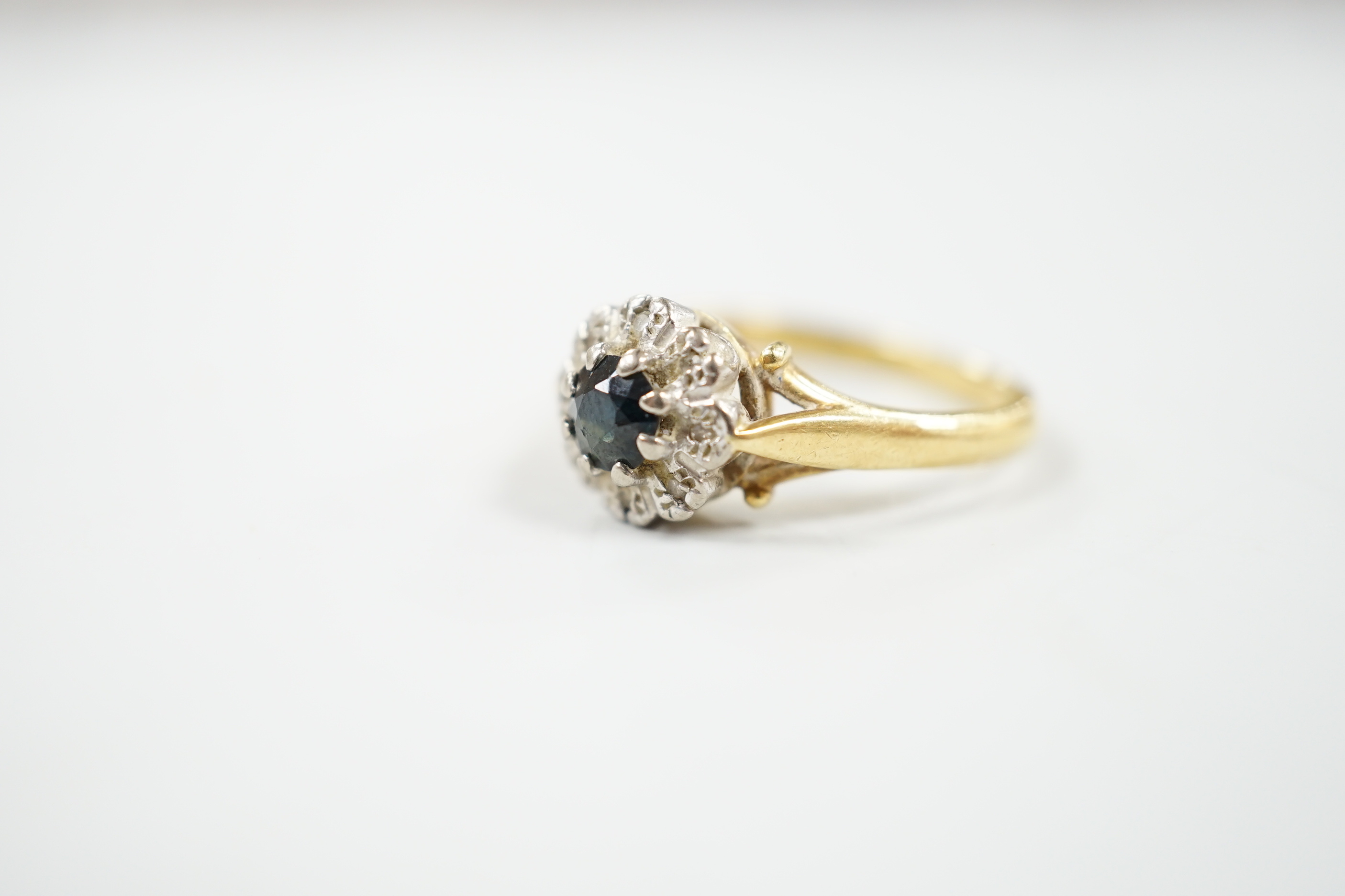 A 1960's 18ct gold, sapphire and diamond chip set cluster ring, size M, gross weight 4.9 grams.